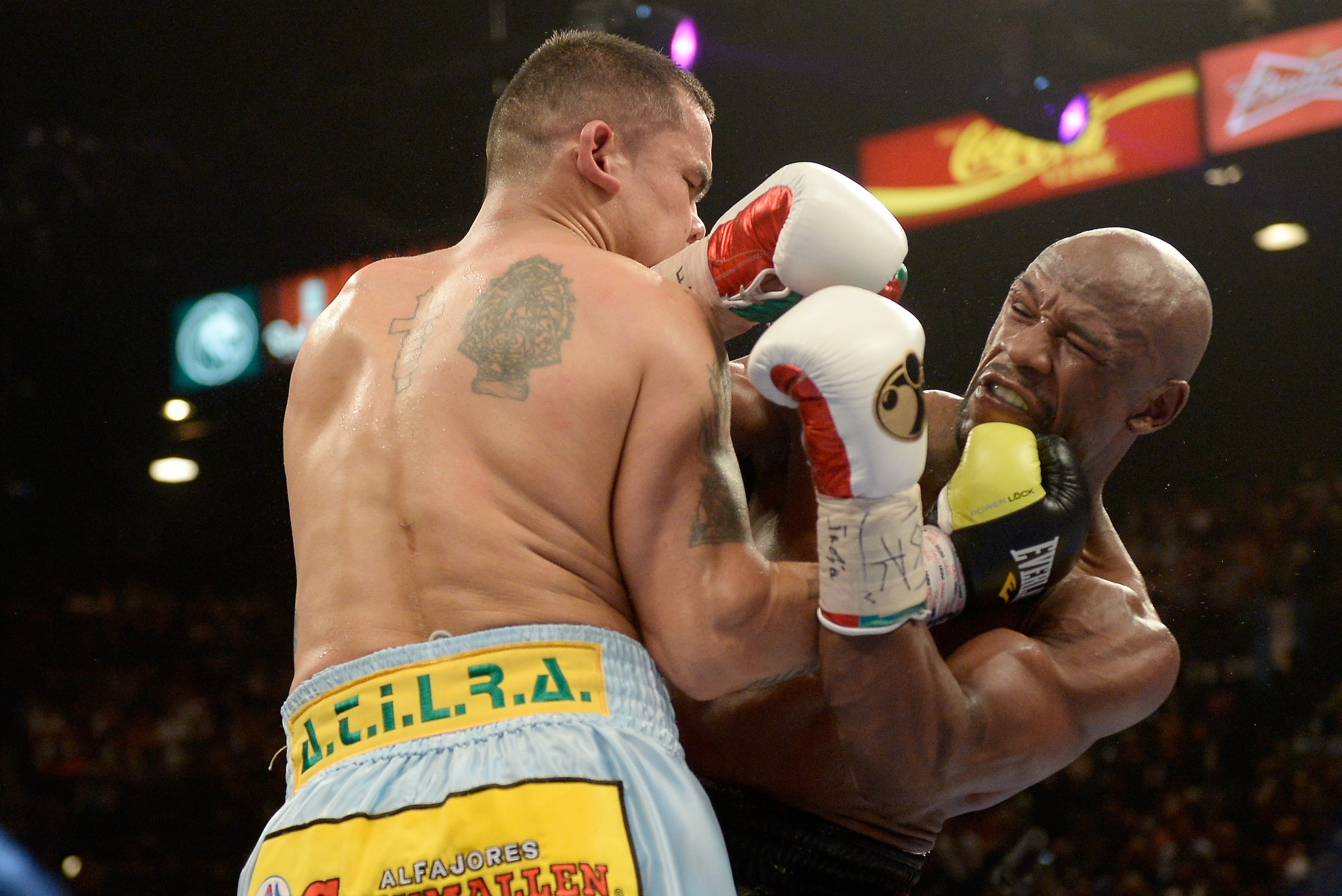LAS VEGAS, NV - MAY 03:  (L-R) Marcos Maidana and  Floyd Mayweather Jr. exchange blows during their WBC/WBA welterweight unification fight at the MGM Grand Garden Arena on May 3, 2014 in Las Vegas, Nevada. Mayweather took Maidana's title with a majority-decision victory.  (Photo by Harry How/Getty Images)