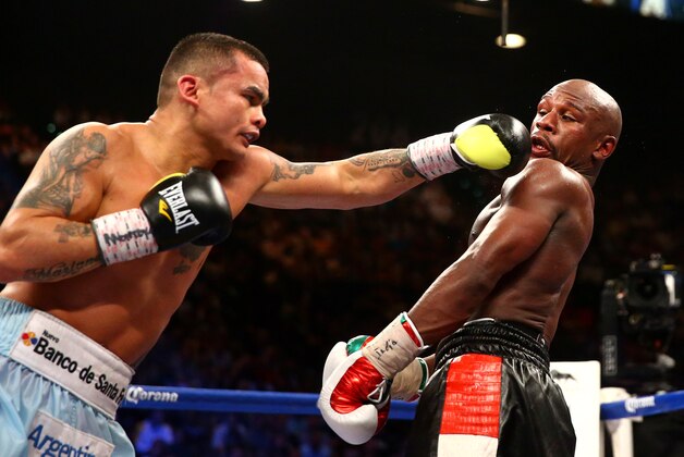 May 3, 2014; Las Vegas, NV, USA; Marcos Maidana (left) hits Floyd Mayweather Jr during their fight at MGM Grand. Mandatory Credit: Mark J. Rebilas-USA TODAY Sports