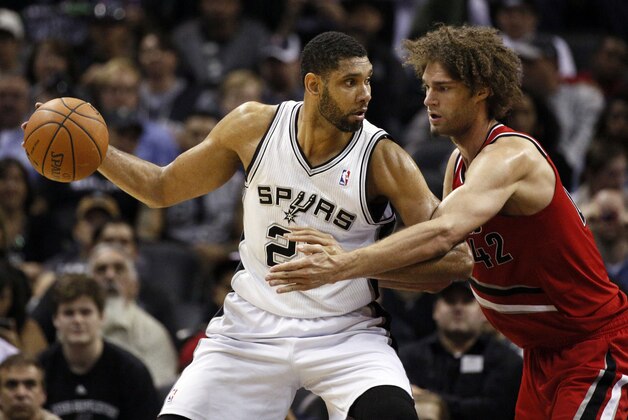 Mar 12, 2014; San Antonio, TX, USA; San Antonio Spurs forward Tim Duncan (21) posts up against Portland Trail Blazers center Robin Lopez (42) during the second half at AT&T Center. The Spurs won 103-90. Mandatory Credit: Soobum Im-USA TODAY Sports
