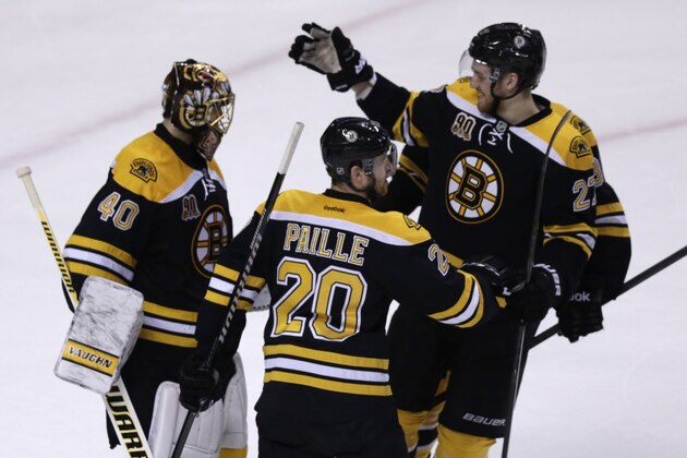 Boston Bruins goalie Tuukka Rask (40) is congratulated by teammates Dougie Hamilton (27) and Daniel Paille (20) after beating the Montreal Canadiens during Game 2 in the second-round of the Stanley Cup hockey playoff series in Boston, Saturday, May 3, 2014. The Bruins defeated the Canadiens 5-3, tying the series at one game each. (AP Photo/Charles Krupa)