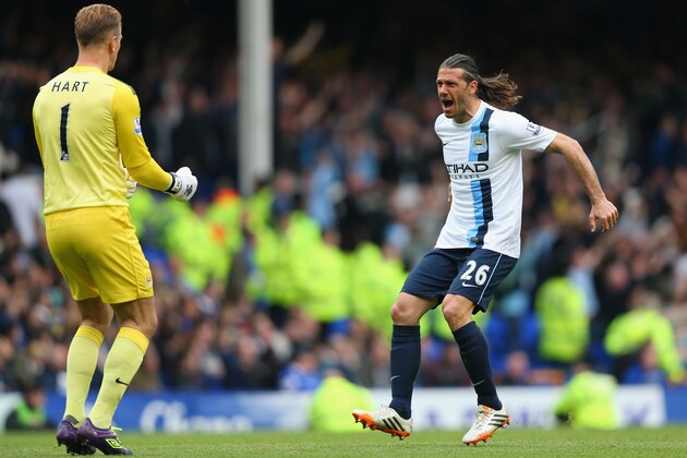 LIVERPOOL, ENGLAND - MAY 03:  Martin Demichelis of Manchester City celebrates his team's second goal with team-mate Joe Hart during the Barclays Premier League match between Everton and Manchester City at Goodison Park on May 3, 2014 in Liverpool, England.  (Photo by Clive Brunskill/Getty Images)