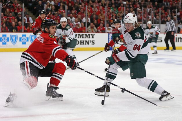 CHICAGO, IL - MAY 04:  Niklas Hjalmarsson #4 of the Chicago Blackhawks blocks a shot by Mikael Granlund #64 of the Minnesota Wild in Game Two of the Second Round of the 2014 NHL Stanley Cup Playoffs at the United Center on May 4, 2014  in Chicago, Illinois.  (Photo by Jonathan Daniel/Getty Images)
