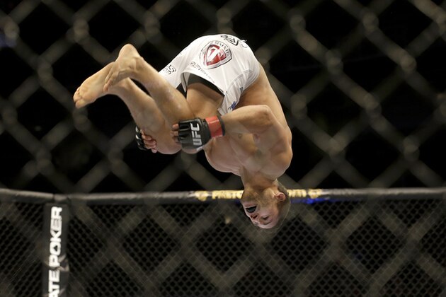 Chad Mendes back flips while celebrating after beating Darren Elkins during the first round of a UFC featherweight mixed martial arts fight in San Jose, Calif., Saturday, April 20, 2013. Mendes won by technical knock out in the first round. (AP Photo/Jeff Chiu)