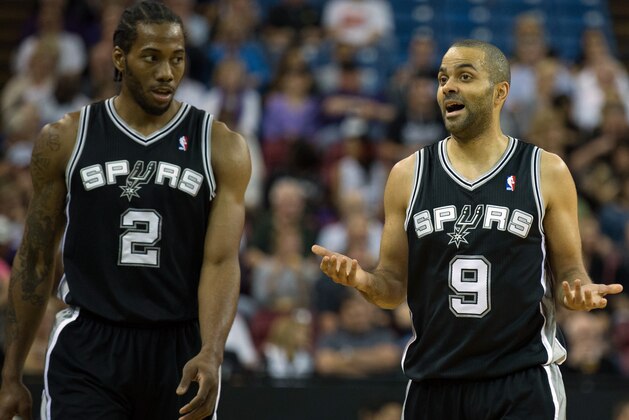 Mar 21, 2014; Sacramento, CA, USA; San Antonio Spurs guard Tony Parker (9) and forward Kawhi Leonard (2) between plays against the Sacramento Kings during the first quarter at Sleep Train Arena. Mandatory Credit: Kelley L Cox-USA TODAY Sports