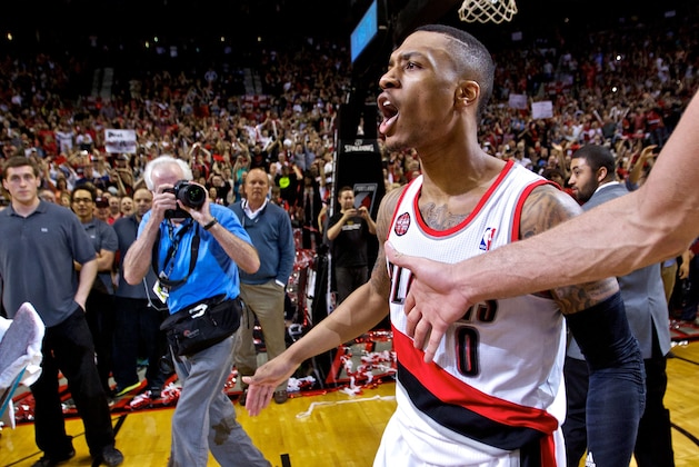 May 2, 2014; Portland, OR, USA; Portland Trail Blazers guard Damian Lillard (0) reacts after hitting the game winning shot against the Houston Rockets during the fourth quarter in game six of the first round of the 2014 NBA Playoffs at the Moda Center. Mandatory Credit: Craig Mitchelldyer-USA TODAY Sports
