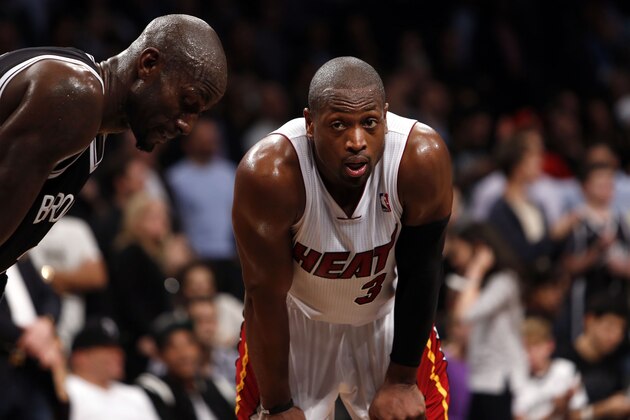 Miami Heat's Dwyane Wade (3) stands with Brooklyn Nets' Kevin Garnett during an NBA basketball game Friday, Nov. 1, 2013, in New York. (AP Photo/Jason DeCrow)
