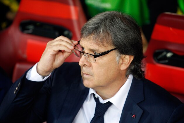 Barcelona's coach Gerardo Martino waits for the start of the Champions League quarterfinal second leg soccer match between Atletico Madrid and FC Barcelona in the Vicente Calderon stadium in Madrid, Spain, Wednesday, April 9, 2014. (AP Photo/Paul White)