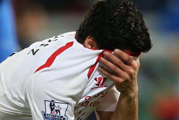 Liverpool's Luis Suarez, holds his shirt to his face following the end of the English Premier League soccer match between Crystal Palace and Liverpool at Selhurst Park stadium in London, Monday, May 5, 2014. The game ended in a 3-3 draw. (AP Photo/Alastair Grant)