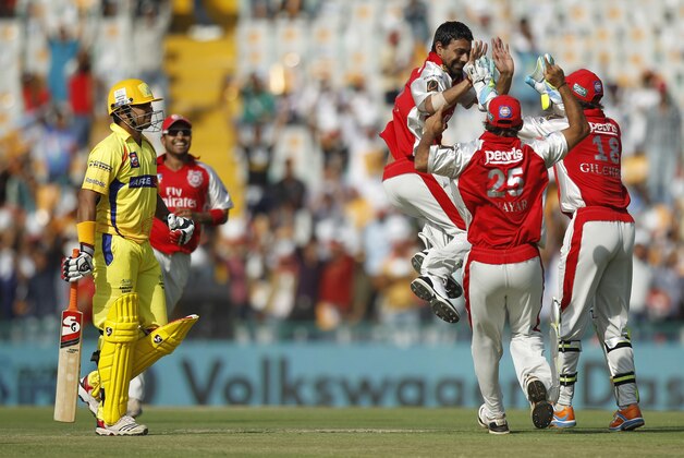 Kings XI Punjab player Praveen Kumar, third right, celebrates with teammates as he claims the wicket of Chennai Super Kings batsman Suresh Raina, left, during an Indian Premier League cricket match between Kings XI Punjab and Chennai Super Kings in Mohali, India, Wednesday, April 13, 2011. The fourth edition of the world's richest cricket tournament scheduled between April 8-May 28 comprises of 10 teams and 74 matches. (AP Photo/Saurabh Das)