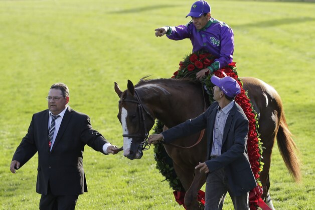 Victor Espinoza celebrates after riding California Chrome to victory in the 140th running of the Kentucky Derby horse race at Churchill Downs Saturday, May 3, 2014, in Louisville, Ky. (AP Photo/David J. Phillip)