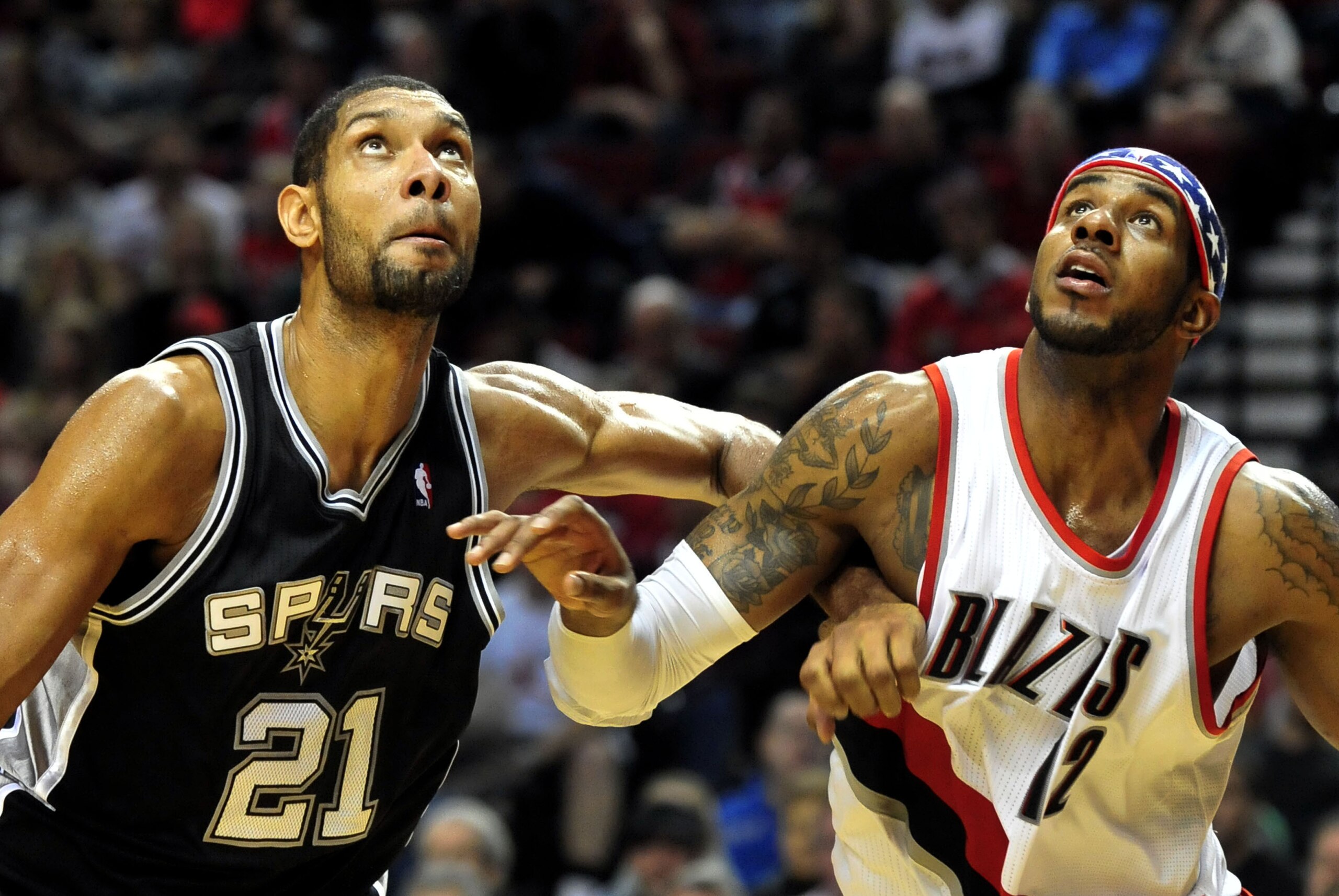 Nov. 10, 2012; Portland, OR, USA; Portland Trail Blazers power forward LaMarcus Aldridge (12) battles for a rebound with San Antonio Spurs power forward Tim Duncan (21) during the fourth quarter of the game at the Rose Garden. The Spurs won the game 112-109.  Mandatory Credit: Steve Dykes-USA TODAY Sports