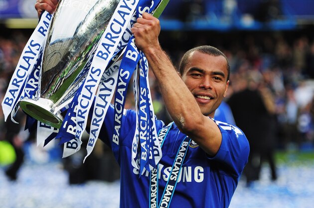 LONDON, ENGLAND - MAY 09:  Ashley Cole of Chelsea celebrates with the trophy as they win the title after the Barclays Premier League match between Chelsea and Wigan Athletic at Stamford Bridge on May 9, 2010 in London, England. Chelsea won 8-0 to win the championship.  (Photo by Shaun Botterill/Getty Images)