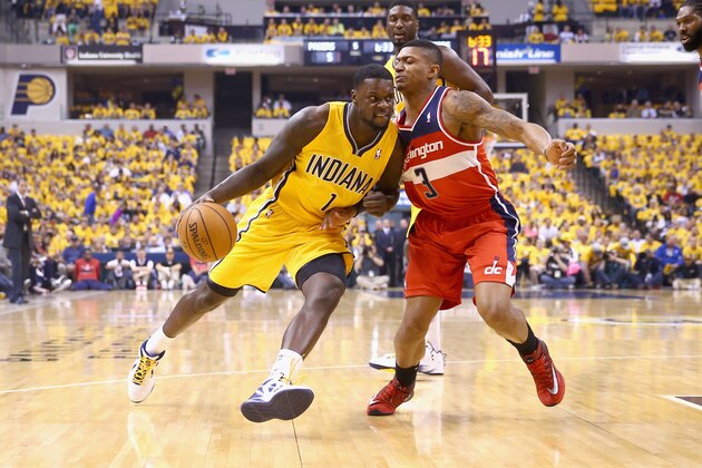 INDIANAPOLIS, IN - MAY 05: Lance Stephenson #1  of the Indiana Pacers dribbles the ball while defended by Bradley Beal #3 of the Washington Wizards in Game 1 of the Eastern Conference Semifinals during the 2014 NBA Playoffs at Bankers Life Fieldhouse on May 5, 2014 in Indianapolis, Indiana. NOTE TO USER: User expressly acknowledges and agrees that, by downloading and or using this photograph, User is consenting to the terms and conditions of the Getty Images License Agreement.  (Photo by Andy Lyons/Getty Images)