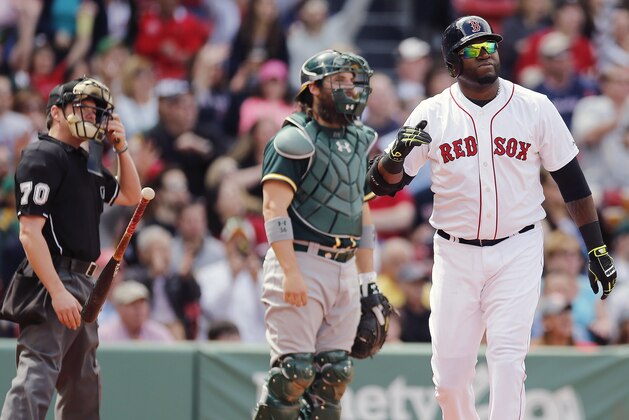 Boston Red Sox's David Ortiz, right, flips his bat in front of Oakland Athletics' Derek Norris after hitting a solo home run in the third inning of a baseball game in Boston, Saturday, May 3, 2014. (AP Photo/Michael Dwyer)