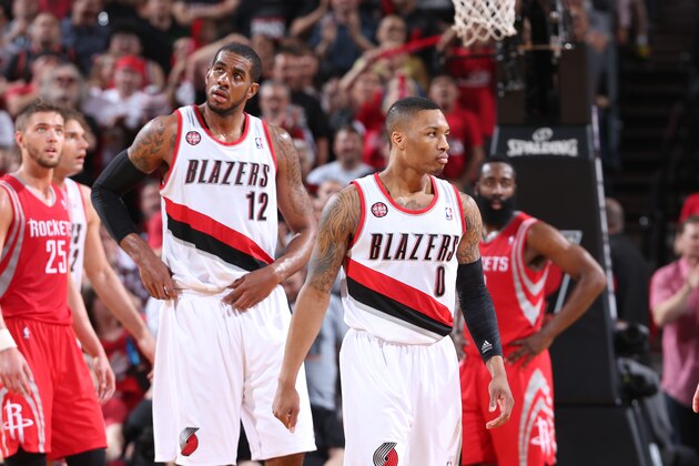 PORTLAND, OR - MAY 2:  LaMarcus Aldridge #12 and Damian Lillard #0 of the Portland Trail Blazers walk off the court against the Houston Rockets in Game Six of the Western Conference Quarterfinals during the 2014 NBA Playoffs on May 2, 2014 at the Moda Center in Portland, Oregon. NOTE TO USER: User expressly acknowledges and agrees that, by downloading and or using this photograph, User is consenting to the terms and conditions of the Getty Images License Agreement. Mandatory Copyright Notice: Copyright 2014 NBAE (Photo by Sam Forencich/NBAE via Getty Images)