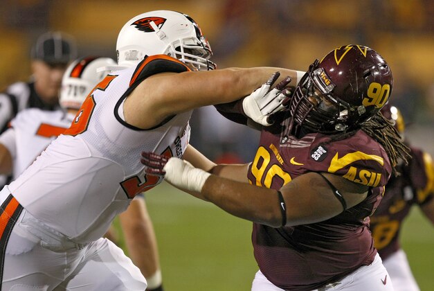 Arizona State defensive tackle Will Sutton (90) battles with Oregon State center Isaac Seumalo (56) during the first half of an NCAA college football game on Saturday, Nov. 16, 2013, in Tempe, Ariz. (AP Photo/Rick Scuteri)