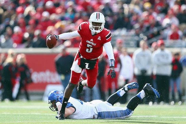 LOUISVILLE, KY - NOVEMBER 23:  Teddy Bridgewater #5 of the Louisville Cardinals avoids the tackle of Chase Rome #47 of the Memphis Tigers at Papa John's Cardinal Stadium on November 23, 2013 in Louisville, Kentucky.  (Photo by Andy Lyons/Getty Images)