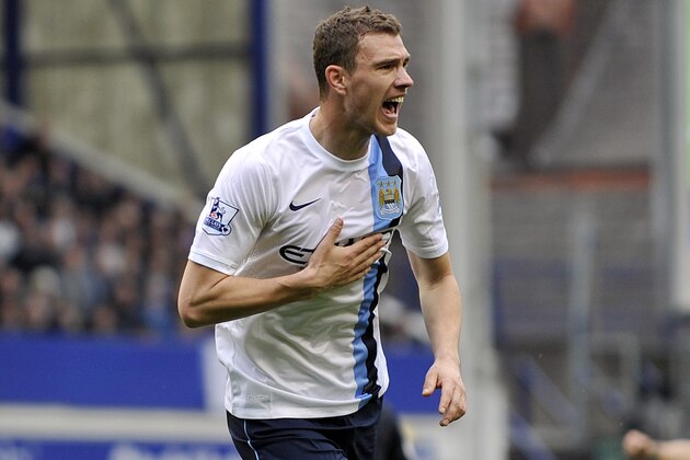 Manchester City's Edin Dzeko celebrates after scoring the second goal of the game during their English Premier League soccer match against Everton at Goodison Park in Liverpool, England, Saturday May 3, 2014. (AP Photo/Clint Hughes)