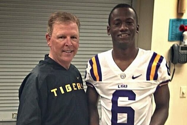 LSU offensive coordinator Cam Cameron (left) stands with dual-threat quarterback prospect Torrance Gibson (right).