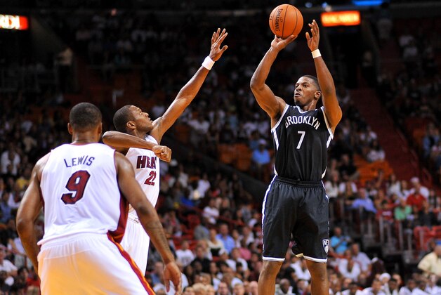 Oct 25, 2013; Miami, FL, USA; Brooklyn Nets shooting guard Joe Johnson (7) shoots over Miami Heat small forward James Jones (22) during their game at American Airlines Arena. Mandatory Credit: Steve Mitchell-USA TODAY Sports