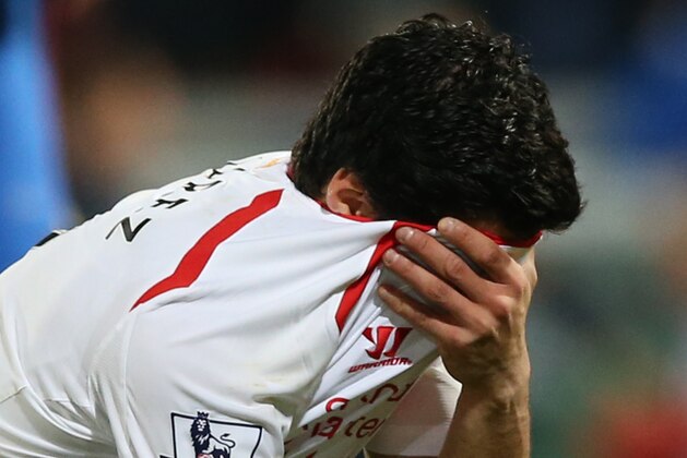 Liverpool's Luis Suarez, holds his shirt to his face following the end of the English Premier League soccer match between Crystal Palace and Liverpool at Selhurst Park stadium in London, Monday, May 5, 2014. The game ended in a 3-3 draw. (AP Photo/Alastair Grant)