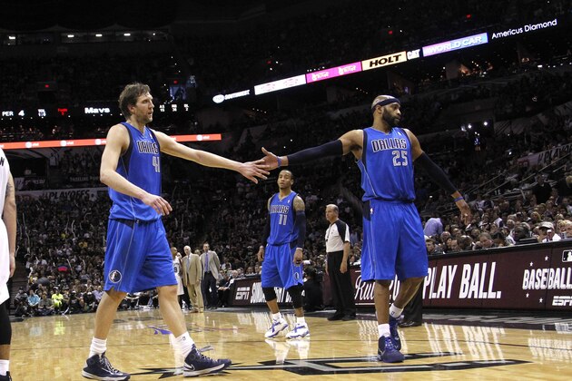 SAN ANTONIO, TX - MAY 4: Dirk Nowitzki #41 and Vince Carter #25 of the Dallas Mavericks slap hands as they leave the court for the final time against the San Antonio Spurs in Game Seven of the Western Conference Quarterfinals during the 2014 NBA Playoffs at the AT&T Center on May 4, 2014 in San Antonio, Texas. NOTE TO USER: User expressly acknowledges and agrees that, by downloading and/or using this photograph, user is consenting to the terms and conditions of the Getty Images License Agreement. (Photo by Chris Covatta/Getty Images)