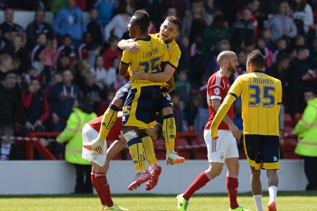 NOTTINGHAM, ENGLAND - MAY 03: Jake Foster-Caskey of Brighton & Hove Albion celebrates with team-mate Kazenga LuaLua at the final whistle with Kazenga Lualua during the Sky Bet Championship match between Nottingham Forest and Brighton & Hove Albion at City Ground on May 03, 2014 in Nottingham, England, (Photo by Tony Marshall/Getty Images)