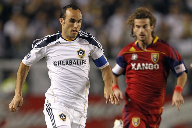 Los Angeles Galaxy forward/midfielder Landon Donovan, left, handles the ball upfield as Real Salt Lake midfielder Kyle Beckerman trails during the first half of an MLS soccer match, Saturday, April 17, 2010, in Carson, Calif. (AP Photo/Alex Gallardo)