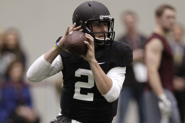 Texas A&M quarterback Johnny Manziel passes the ball during a drill at pro day for NFL football representatives in College Station, Texas, Thursday, March 27, 2014. (AP Photo/Patric Schneider)