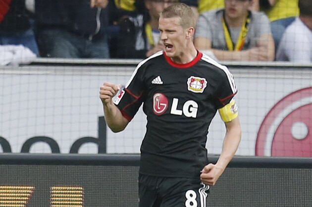 Leverkusen's Lars Bender celebrates his side's opening goal during a German Bundesliga soccer match between Bayer 04 Leverkusen and Borussia Dortmund in Leverkusen, Germany, Saturday, April 26, 2014. (AP Photo/Michael Probst)