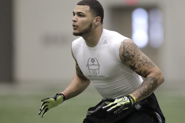 Texas A&M wide receiver Mike Evans works out during pro day for NFL football representatives in College Station, Texas, Thursday, March 27, 2014. (AP Photo/Patric Schneider)