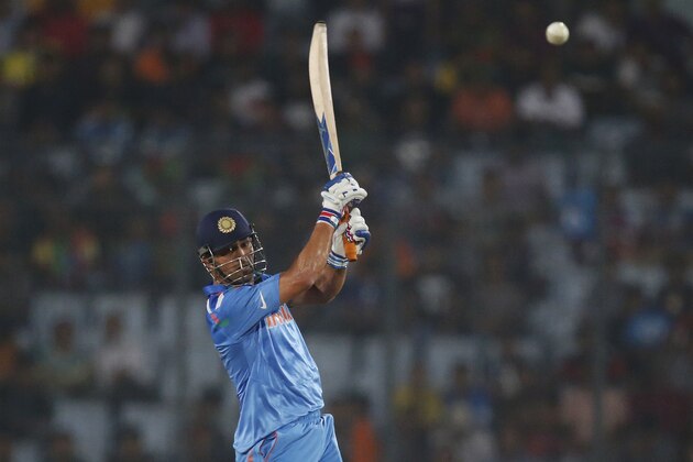 India's captain Mahendra Singh Dhoni plays a shot during their ICC Twenty20 Cricket World Cup match against Australia in Dhaka, Bangladesh, Sunday, March 30, 2014. (AP Photo/Aijaz Rahi)