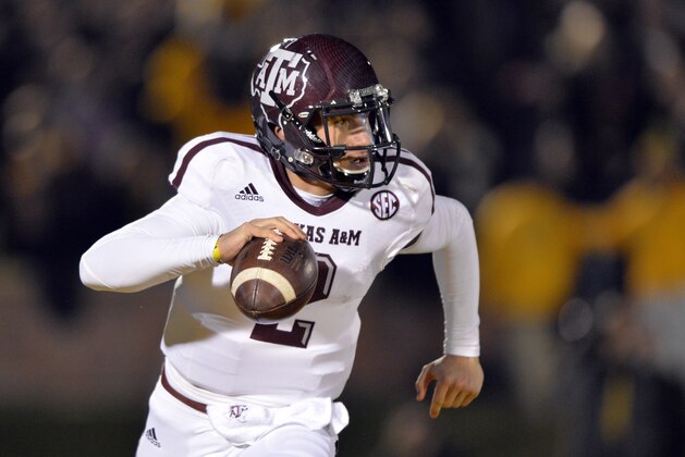 Nov 30, 2013; Columbia, MO, USA; Texas A&M Aggies quarterback Johnny Manziel (2) scrambles to the outside against the Missouri Tigers during the first half at Faurot Field. Mandatory Credit: Peter G. Aiken-USA TODAY Sports