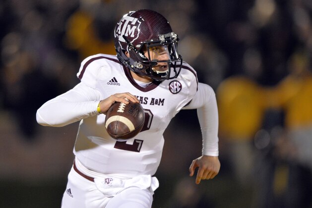 Nov 30, 2013; Columbia, MO, USA; Texas A&M Aggies quarterback Johnny Manziel (2) scrambles to the outside against the Missouri Tigers during the first half at Faurot Field. Mandatory Credit: Peter G. Aiken-USA TODAY Sports
