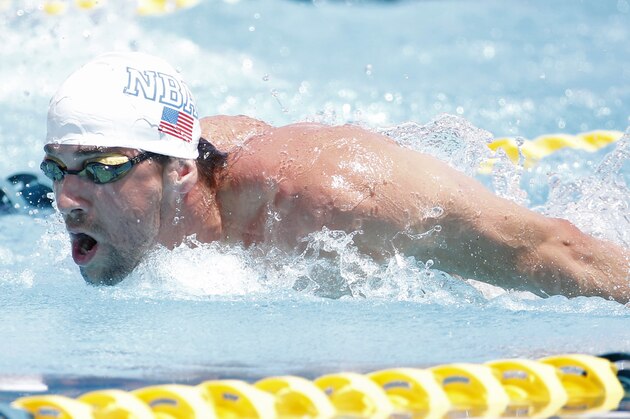 Michael Phelps competes in the 100-meter butterfly during the Arena Grand Prix, Thursday, April 24, 2014, in Mesa, Ariz. It is Phelps' first competitive event after a nearly two-year retirement. (AP Photo/Matt York)
