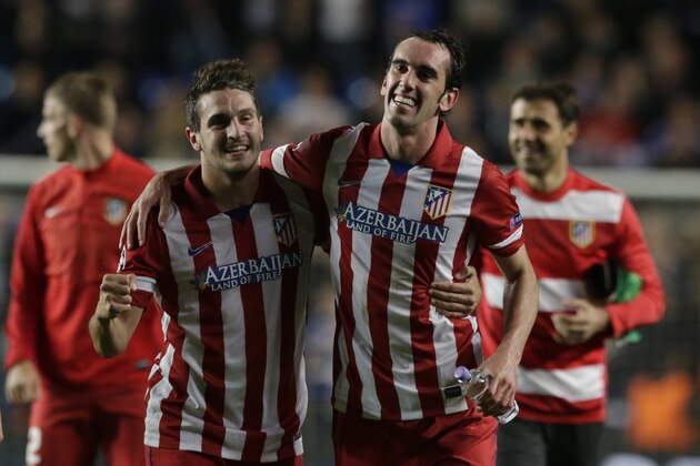 Atletico's Koke, left and teammate Atletico's Diego Godin celebrate in front of their fans after defeating Chelsea in the Champions League semifinal second leg soccer match between Chelsea and Atletico Madrid at Stamford Bridge stadium in London, Wednesday, April 30, 2014. (AP Photo/Matt Dunham)