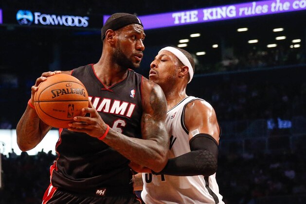 Oct 17, 2013; Brooklyn, NY, USA;  Brooklyn Nets small forward Paul Pierce (34) holds off Miami Heat small forward LeBron James (6) during the first quarter at Barclays Center. Mandatory Credit: Anthony Gruppuso-USA TODAY Sports