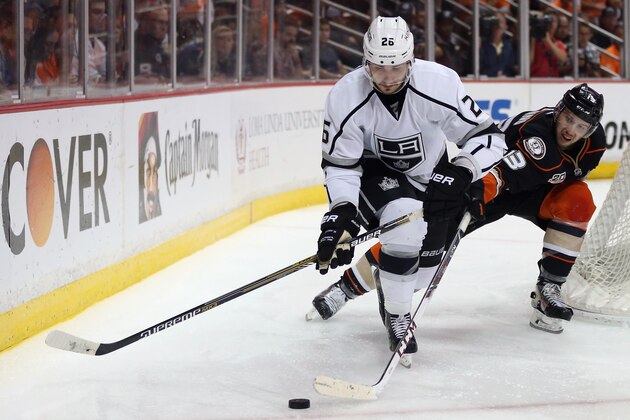 ANAHEIM, CA - MAY 03:  Slava Voynov #26 of the Los Angeles Kings is pursued by Nick Bonino #13 of the Anaheim Ducks for the puck in Game One of the Second Round of the 2014 NHL Stanley Cup Playoffs at Honda Center on May 3, 2014 in Anaheim, California.  (Photo by Jeff Gross/Getty Images)