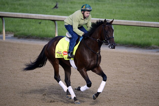May 1, 2014; Louisville, KY, USA; Exercise rider Simon Paine works out Kentucky Derby hopeful Samraat during morning workouts at Churchill Downs. Mandatory Credit: Jamie Rhodes-USA TODAY Sports