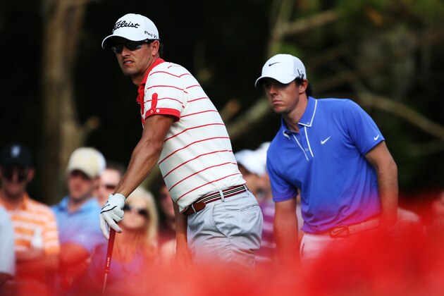 PONTE VEDRA BEACH, FL - MAY 10:  Adam Scott of Australia plays a shot from the 15th tee as Rory McIlroy of Northern Ireland looks on during round two of THE PLAYERS Championship at THE PLAYERS Stadium course at TPC Sawgrass on May 10, 2013 in Ponte Vedra Beach, Florida.  (Photo by Richard Heathcote/Getty Images)