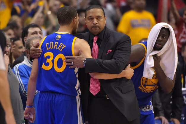 Golden State Warriors head coach Mark Jackson, center, hugs guard Stephen Curry after Curry was taken out of the game as forward Draymond Green looks on during the second half in Game 7 of an opening-round NBA basketball playoff series, Saturday, May 3, 2014, in Los Angeles. The Clippers won 126-121. (AP Photo/Mark J. Terrill)