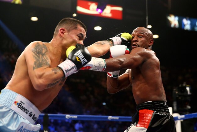 May 3, 2014; Las Vegas, NV, USA; Floyd Mayweather Jr. (right) is punched by Marcos Maidana during their fight at MGM Grand. Mandatory Credit: Mark J. Rebilas-USA TODAY Sports