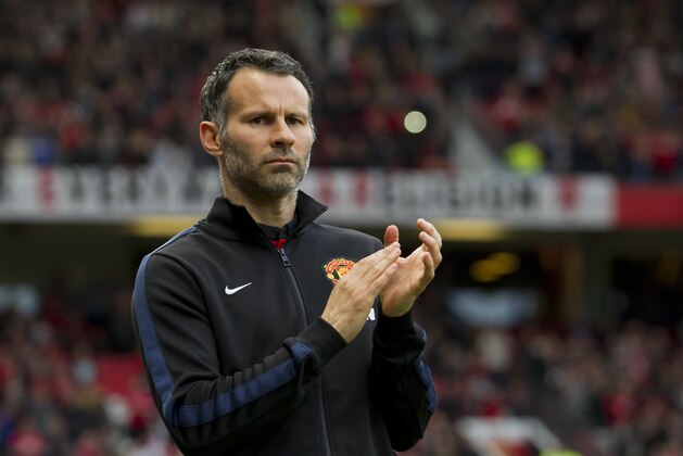 Manchester United's interim manager Ryan Giggs applauds before his team's English Premier League soccer match against Hull at Old Trafford Stadium, Manchester, England, Tuesday, May 6, 2014. (AP Photo/Jon Super)