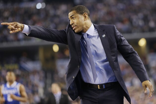 Connecticut head coach Kevin Ollie directs action against Kentucky during the first half of the NCAA Final Four tournament college basketball championship game Monday, April 7, 2014, in Arlington, Texas. (AP Photo/Eric Gay)