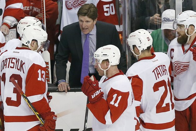 Detroit Red Wings head coach Mike Babcock talks with his team during a timeout in the third period against the Boston Bruins  in Game 5 in the first round of the NHL hockey Stanley Cup playoffs in Boston, Saturday, April 26, 2014. Boston won 4-2 and eliminated the Red Wings from the playoffs. (AP Photo/Michael Dwyer)