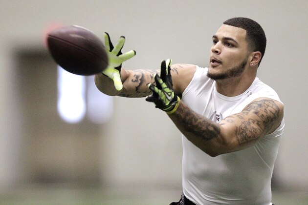 Texas A&M wide receiver Mike Evans catches a pass from quarterback Johnny Manziel during a drill at pro day for NFL football representatives in College Station, Texas, Thursday, March 27, 2014. (AP Photo/Patric Schneider)