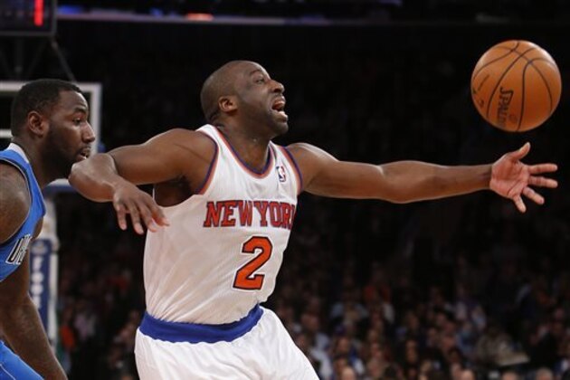 In this Monday, Feb. 24, 2014, photo, New York Knicks' Raymond Felton (2) loses the ball as he drives against Dallas Mavericks' DeJuan Blair during the first half of an NBA basketball game  in New York. Felton was arrested Tuesday on weapons charges after a lawyer for Felton's wife turned in a loaded gun allegedly belonging to the basketball star, saying she didn't want it in her home, police said. Felton turned himself in at 12:50 a.m. Tuesday, not long after the Knicks lost to the Mavericks.  (AP Photo/Jason DeCrow)