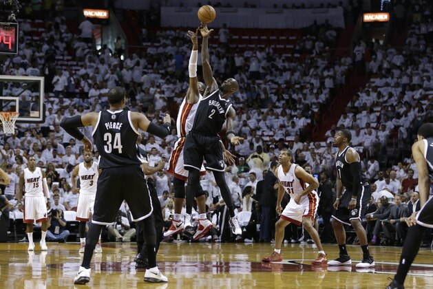 Miami Heat's Chris Bosh, left, and Brooklyn Nets' Kevin Garnett (2) jump up at tip-off in the first half of Game 1 in an Eastern Conference semifinal basketball game, Tuesday, May 6, 2014, in Miami.  (AP Photo/Lynne Sladky)