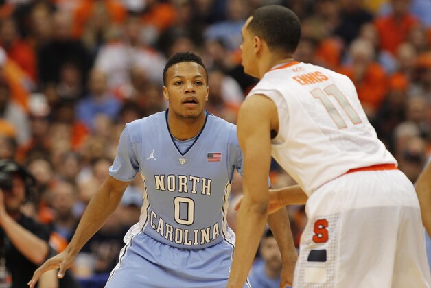North Carolina’s Nate Britt, left, guards Syracuse’s Tyler Ennis, right, in the second half of an NCAA college basketball game in Syracuse, N.Y., Saturday, Jan. 11, 2014. Syracuse won 57-45. (AP Photo/Nick Lisi)