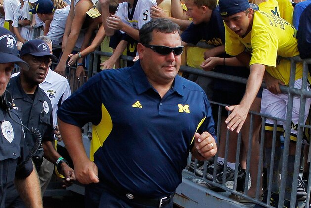 ANN ARBOR, MI - SEPTEMBER 03:  Head coach Brady Hoke of the Michigan Wolverines runs onto the field for his first game as Michigan's head coach prior to playing the Western Michigan Broncos at Michigan Stadium on September 3, 2010 in Ann Arbor, Michigan. (Photo by Gregory Shamus/Getty Images)